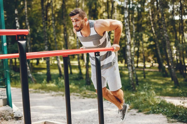 Sports man in a morning summer park — Stock Photo, Image