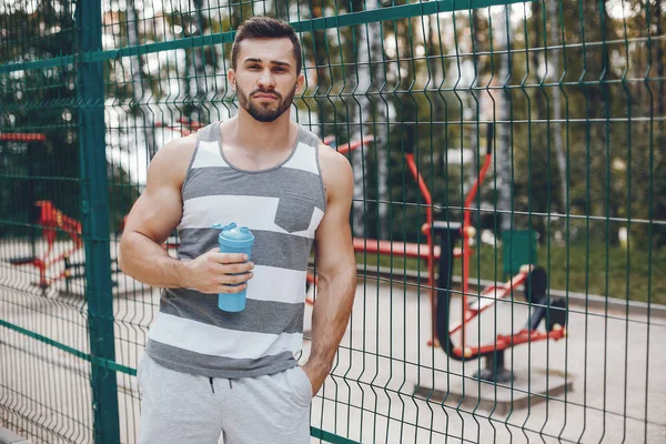 Sports man in a morning summer park — Stock Photo, Image