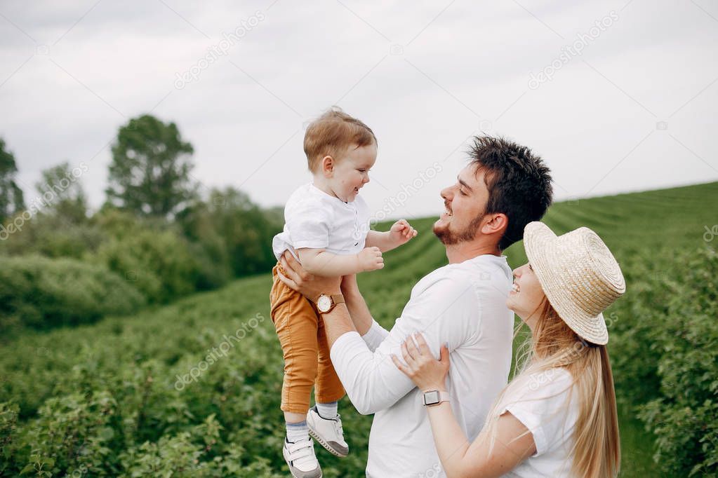 Cute family playing in a summer field