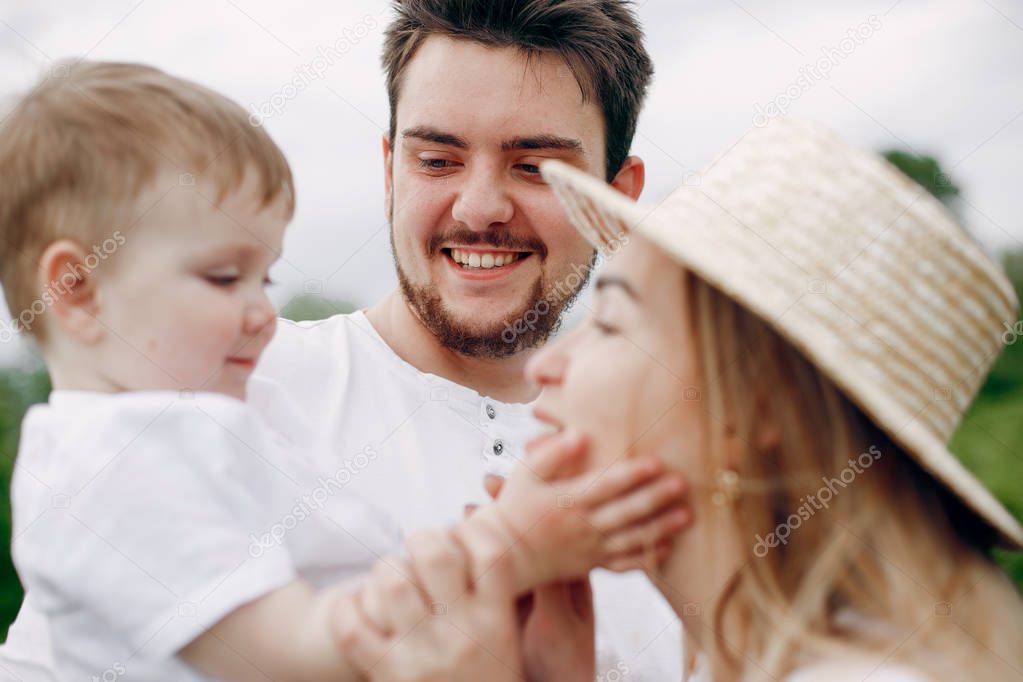 Cute family playing in a summer field