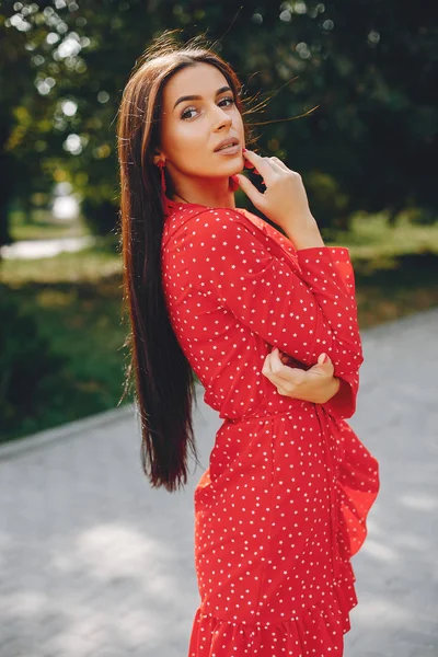 Elegant brunette in a summer city — Stock Photo, Image