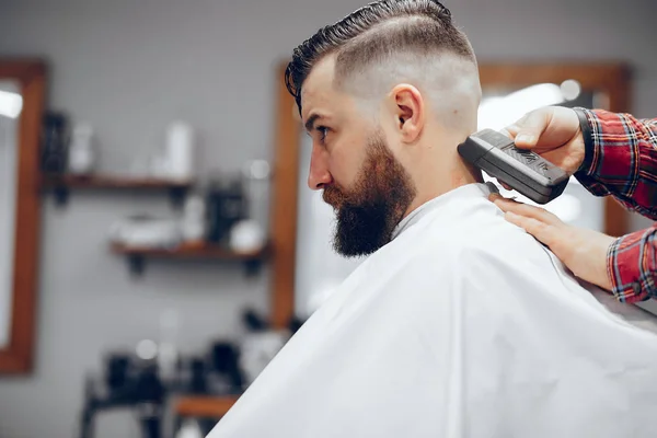 Stylish man sitting in a barbershop — Stock Photo, Image