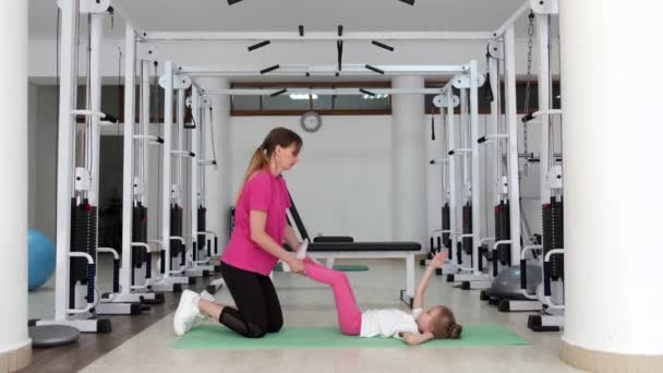 Trainer trainen met een klein meisje in de sportschool — Stockvideo