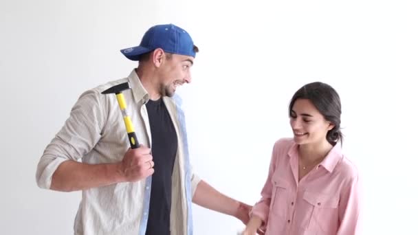 Pareja divirtiéndose mientras trabaja y pintando su apartamento — Vídeo de stock