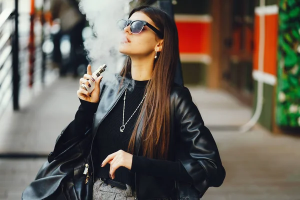 Fille élégante fumant une e-cigarette — Photo