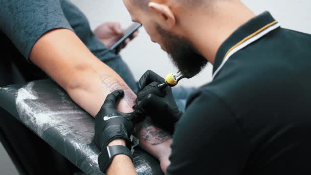 Tatuador masculino tatuando a un cliente — Vídeos de Stock