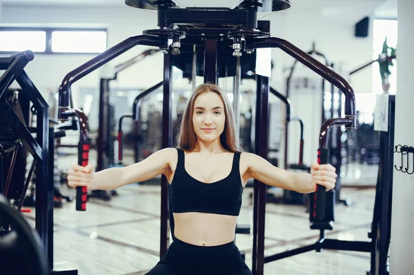 Sports girl in a morning gym — Stock Photo, Image