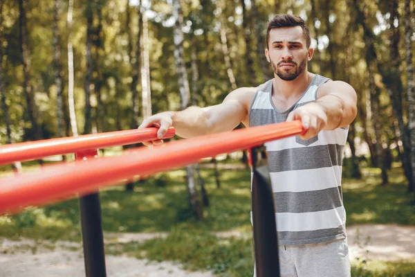 Sports man in a morning summer park — Stock Photo, Image