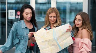 Havaalanı yakınındaki haritaya bakan kızlar