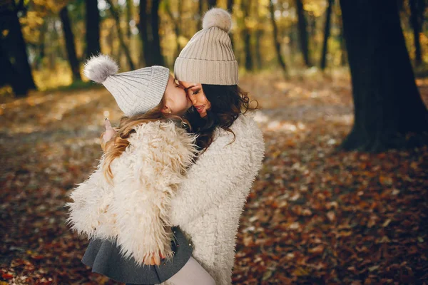 Cute and stylish family in a autumn park — Stock Photo, Image