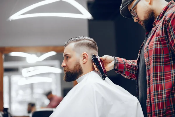 Stilvoller Mann sitzt in einem Friseurladen — Stockfoto