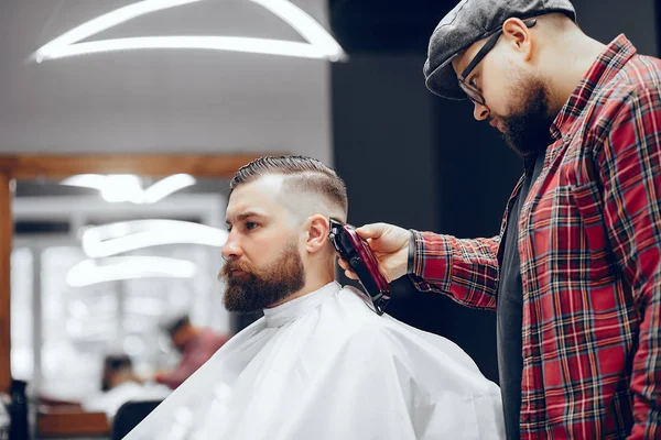 Stilvoller Mann sitzt in einem Friseurladen — Stockfoto