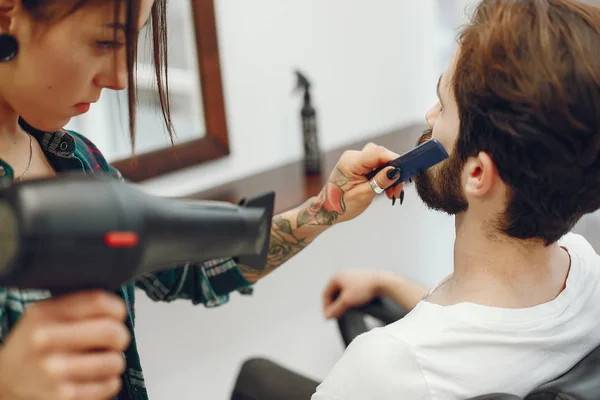 Stylish man sitting in a barbershop — Stock Photo, Image