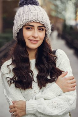 Şehirde beyaz kazak giyen tatlı bir esmer.