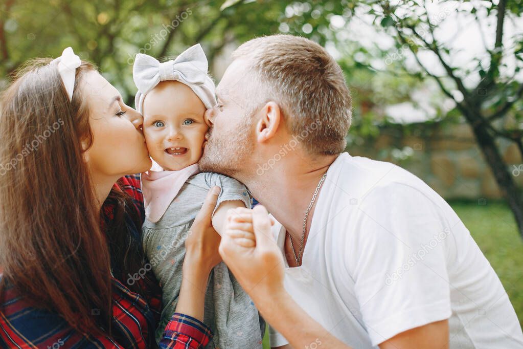 Family with daughter playing in the yard