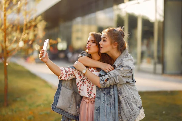 Elegant and stylish girls in a summer park — Stock Photo, Image