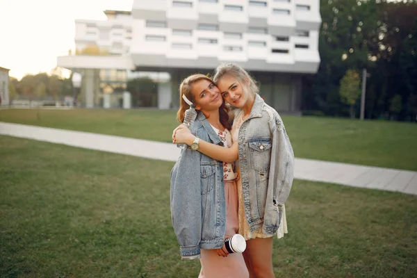 Elegant and stylish girls in a summer park — Stock Photo, Image