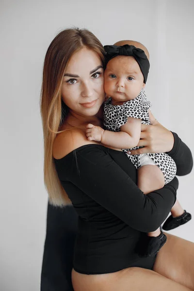 Elegant mother with cute little daughter in a studio — Stock Photo, Image