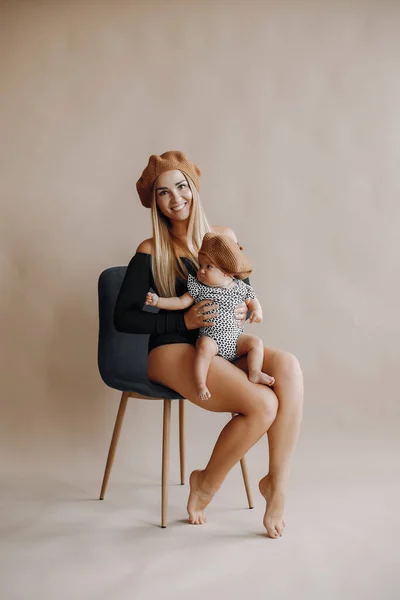 Elegant mother with cute little daughter in a studio — Stock Photo, Image