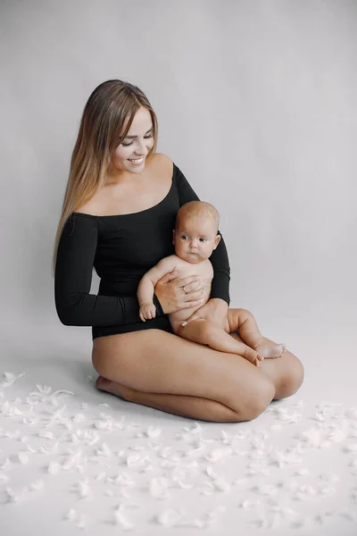 Elegant mother with cute little daughter in a studio — Stock Photo, Image