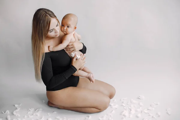 Elegant mother with cute little daughter in a studio — Stock Photo, Image