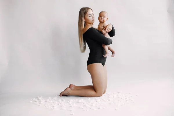 Elegant mother with cute little daughter in a studio — Stock Photo, Image