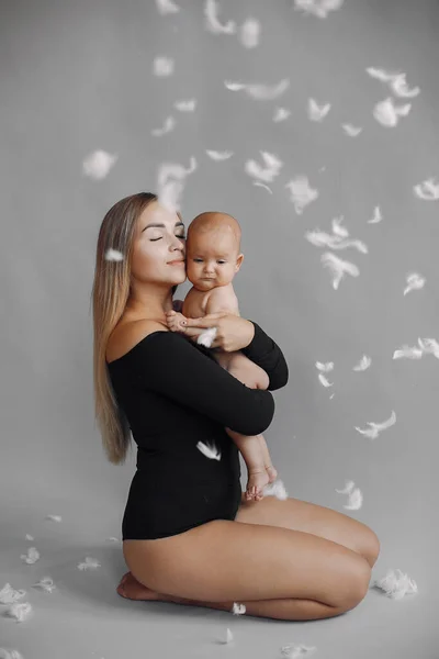 Elegant mother with cute little daughter in a studio — Stock Photo, Image