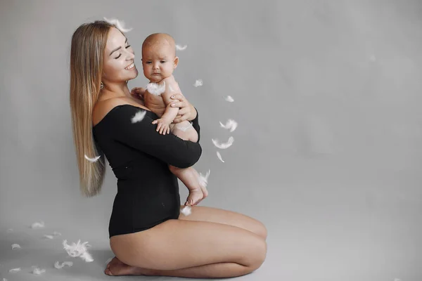 Elegant mother with cute little daughter in a studio — Stock Photo, Image