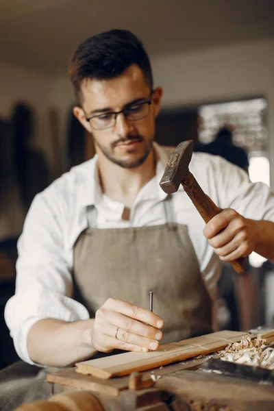 Handsome carpenter working with a wood — Stock Photo, Image