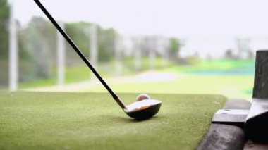Golf sahasında yakın çekim golf sopası Topgolf sahasına bakıyor.