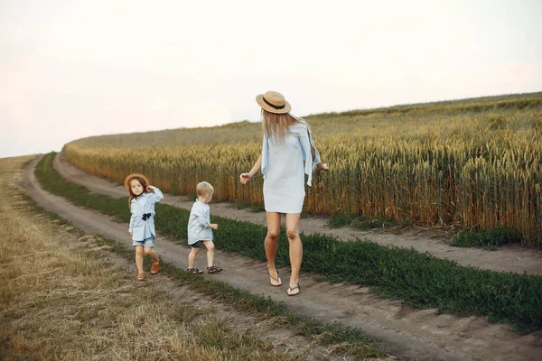 Madre con bambini che giocano in un campo estivo — Foto Stock