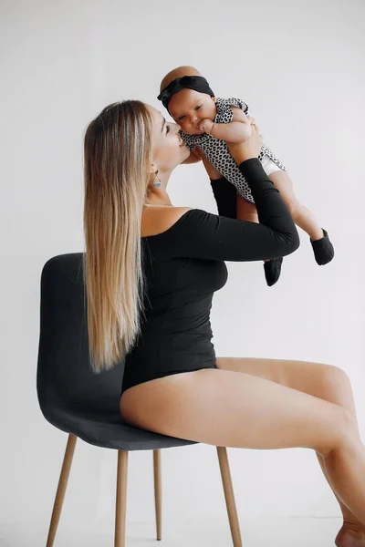 Elegant mother with cute little daughter in a studio — Stock Photo, Image