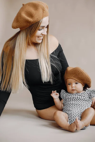 Elegant mother with cute little daughter in a studio — Stock Photo, Image