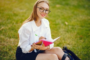 Okul bahçesinde sırt çantalı bir öğrenci.