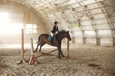 The rider in black form trains with the horse