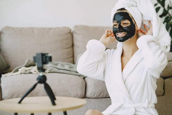 Beautiful girl in a white bathrobe at home — Stock Photo, Image