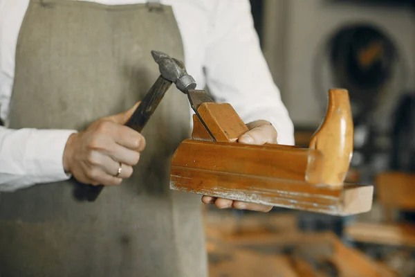 Handsome carpenter working with a wood — Stock Photo, Image