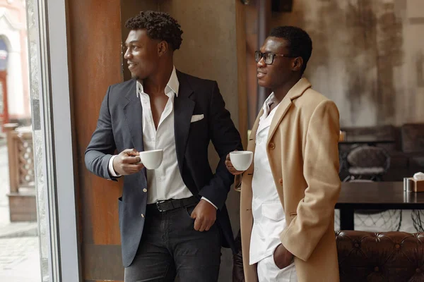 Black men in a cafe have a business