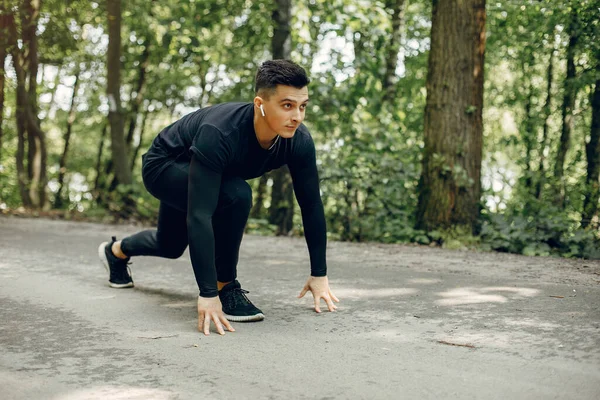 Sports man in a morning summer park — Stock Photo, Image