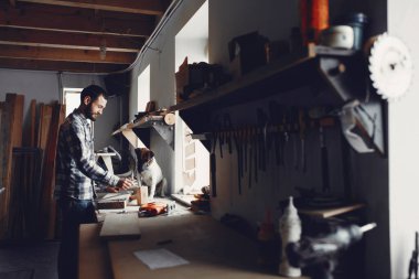 Marangoz bir ağaçla çalışır.