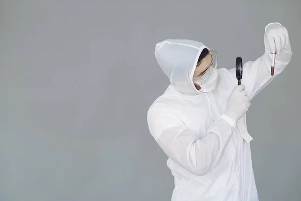 Man in protective suit and glasses in studio