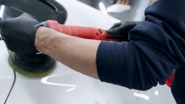 Hombre pulir un coche en un garaje — Vídeos de Stock