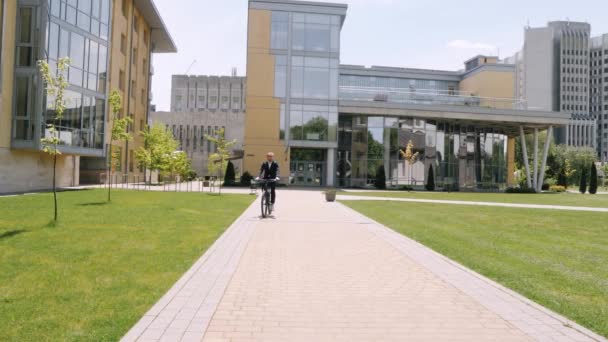 Uomo d'affari con bicicletta in una città estiva — Video Stock