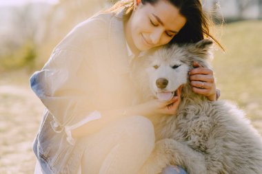 Köpeğiyle bahar tarlasında şık bir kız.