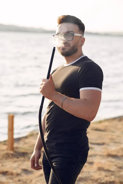 Portrait of bearded man in glasses smoking hookah — Stock Photo, Image