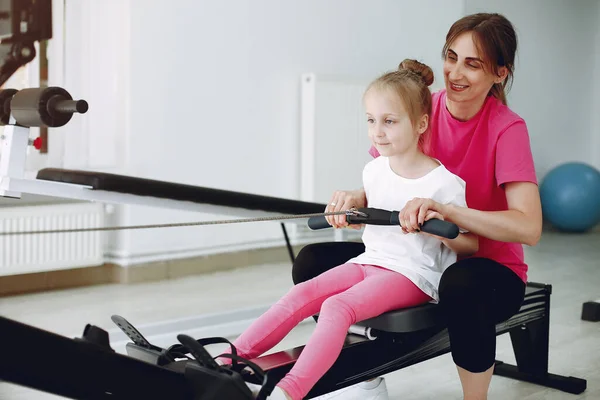 Mother with little daughter are engaged in gymnastics in the gym — Stock Photo, Image