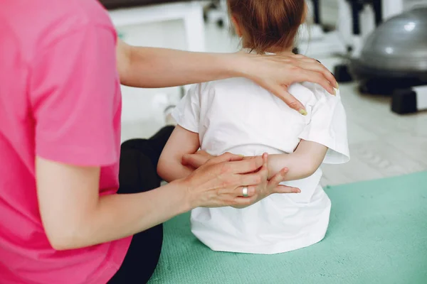 Mother with little daughter are engaged in gymnastics in the gym — Stock Photo, Image