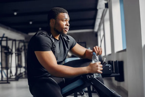 A handsome black man is engaged in a gym