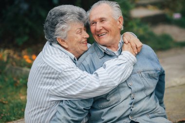 Beautiful old couple spent time together in a park clipart