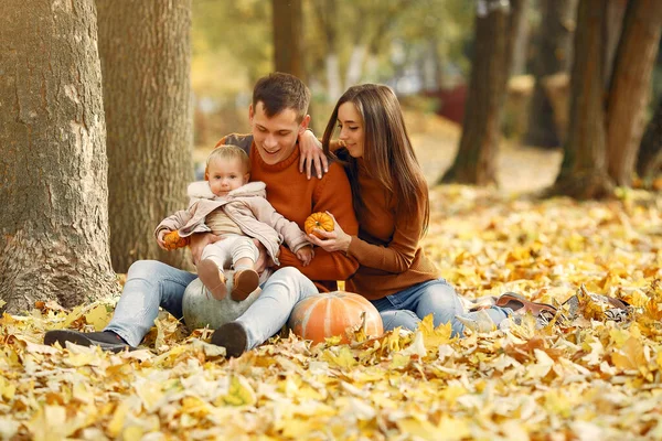 Family with little daughter in a autumn park — Stock Photo, Image